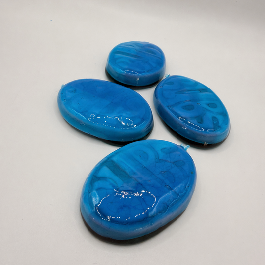 Four blue oval-shaped objects on a gray background