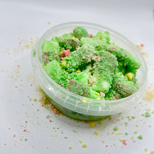 Green textured product in a clear container on a white background